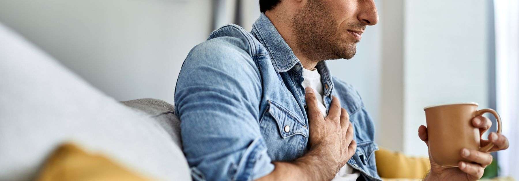 man struggling with acid reflux