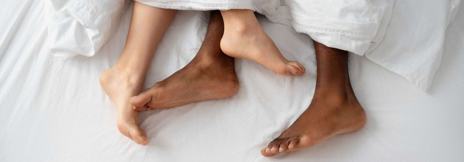 a couple in bed having intimate moments 